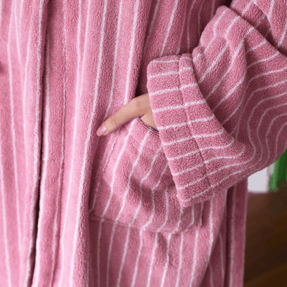 Close-up of a pink robe with white stripes worn by a person.