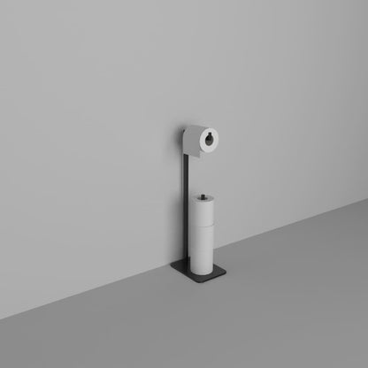 A modern black toilet paper holder stand holding three rolls, positioned against a plain gray wall, showcasing its clean and contemporary style.
