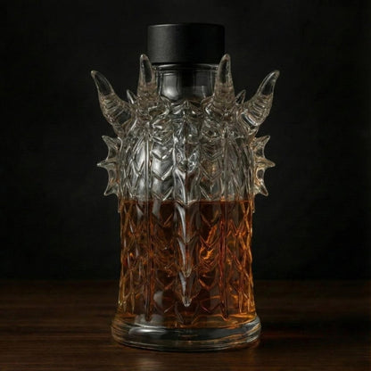 Back view of the Kouvr dragon head decanter, showcasing the textured glass scales and the shape of the horns and neck.