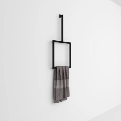 Wall-mounted black vertical towel rack holding a gray towel, set against a plain white background in a minimalist design.